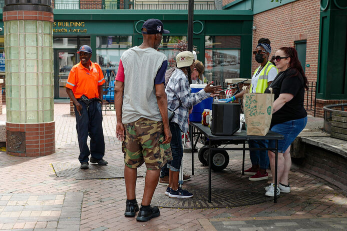 Ambassadors (James L. pictured here) support our Outreach Team serving hot dogs at Carl Barron Plaza